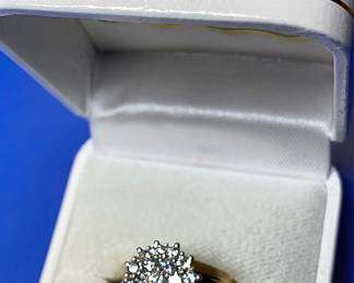 We think NEW and unworn Diamond Cluster ring set in a 14k Solid Gold ring.