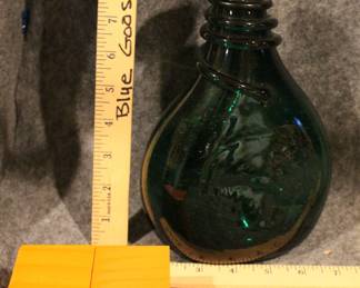 Lot 34:  Sale $60.  Was $120.  Persian Qajar saddle flask, emerald green glass with tooled and wrapped neck (very old)