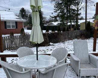 Lloyd Flanders table with umbrella (metal base) and four wicker chairs.