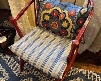 One of two matching spindle-back chairs, cushion included.