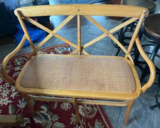 French bistro-style rattan bench.