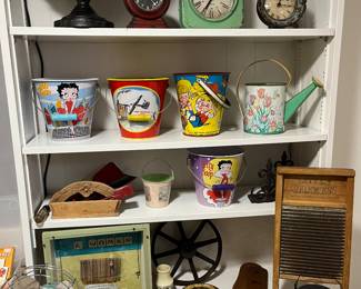 Vintage sand pails, watering pails and shovels; vintage clocks.