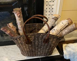 Woven basket with birch logs.