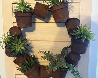 Planter pot wreath with artificial plants.