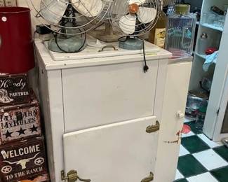 Antique ice box, antique oscillating fans, wooden stacks of Cowboy boxes.  