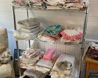 Vintage linens, top shelf are all MCM bridge cloths and table cloths.