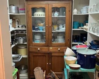 Antique wooden kitchen cupboard, turquoise metal rolling cart.