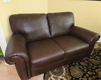Brown leather loveseat