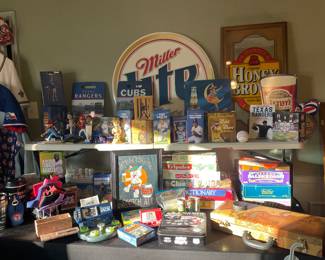 A room filled with Texas Rangers memorabilia, Beer advertising signs, sports shirts, vintage games, electronics and more 