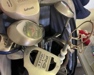 Two sets of golf clubs both women and men