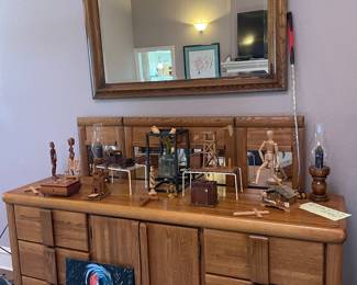 Solid Oak dresser with matching mirror(behind dresser) Wood carved decor and original paintings 