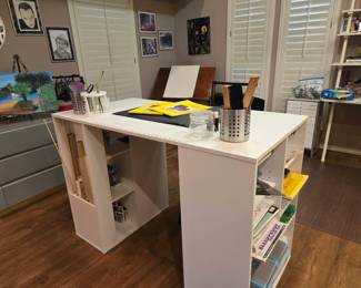 Craft and sewing rooms filled with workstations and supplies 