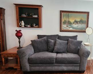 Maple occasional tables, blue loveseat,  pictures, showcase with ducks 