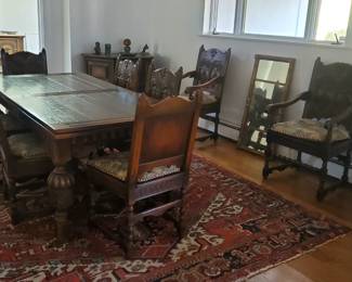 1920's Kittinger Renaissance style dining set. Trestle table with eight chairs. Heavily carved detail.