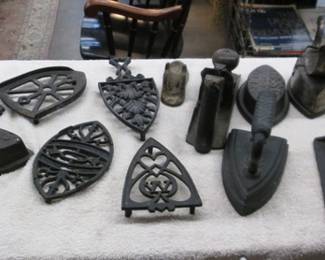 Collection of vintage sad irons and trivets.  