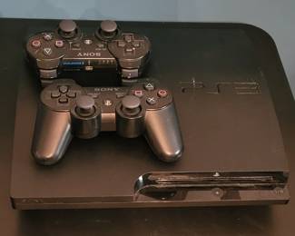Sony Playstation 3 console with two controllers (not pictured are the cords that go with them). 