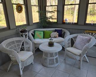 White wicker furniture in sunroom.