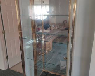 This gold-framed glass front curio has a crack at the base of the back mirror.  Sold as-is.