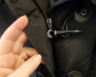 Toggle buttons plus a zipper.