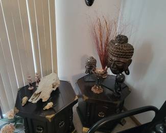 Cow skull, decorative wooden masks, end tables. 