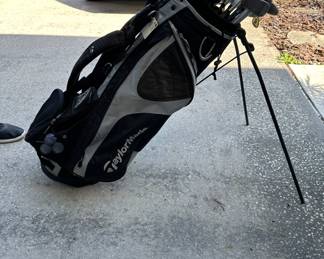 Taylor Made Golf bag with assorted golf clubs