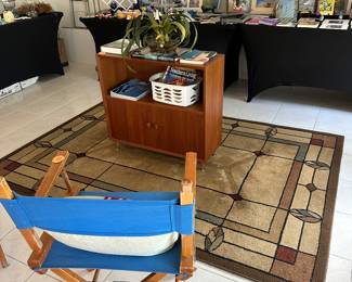 two Blue Director Chairs and a teak cabinet