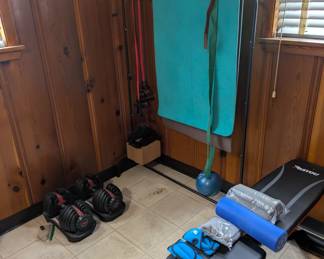 Workout gear. dumbells, weight bench and yoga mat