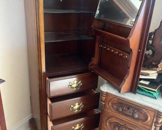 Lexington cherrywood jewelry armoire w/lock and key, glass shelves and interior mirror and light; measures 22"L x 17"H x 56.5"H.