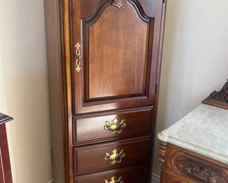 Lexington cherrywood jewelry armoire w/lock and key, glass shelves and interior mirror and light; measures 22"L x 17"H x 56.5"H
