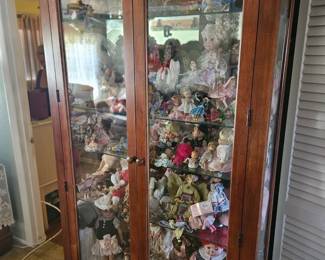 So many dolls all styles and sizes. Priced individually. Glass hutch $125 storage drawer below