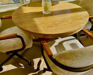 Round kitchen table with leaf and four wheeled bolstered chairs