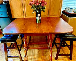 Drop leaf kitchen table with two leather stools