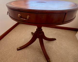 Round accent table with brass claw feet