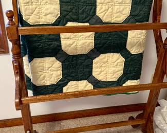 Wood quilt rack with hand stitched quilt