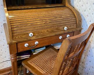 Vintage roll top desk with rattan seat chair