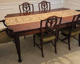 Large ornate diningroom table with six chairs.  2 leaves currently in the table. 81"×46" w leaves/fully extended