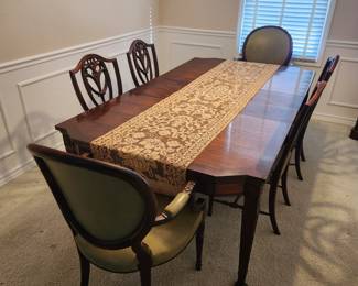 Large ornate diningroom table with six chairs.  2 leaves currently in the table. 81"×46" w leaves/fully extended 