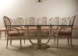 A distinguished contemporary – modern Henredon dining table and chairs, in tempered glass, whitewashed oak and brass. The table, Art Deco in form, the large sculpted edge glass top supported by a curved base of white washed oak with brass tone trim. The chairs, a contemporary form of the Sheraton style, also in white washed oak, with open “wheel” back rests, over tapered, square legs, peach microfiber upholstery, with brass caps on the front legs. The set includes two arm chairs and six side chairs. Beautifully maintained. Companion to items 018, 054, 207, and 208
