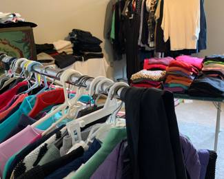 A room filled with Ladies, Men and young girl clothes