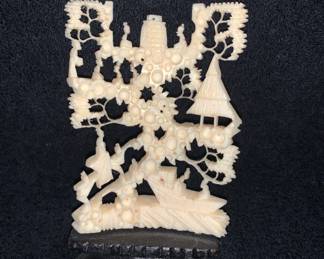 Hand carved Bone Art on black stand