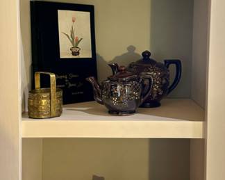 The brass coaster set on the second shelf, and the pink pottery are sold.