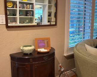 The cabinet and brass bucket on the floor are sold.