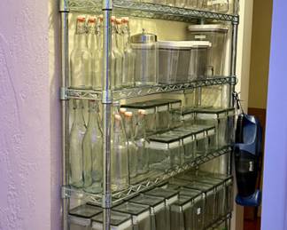 The storage rack and many of the glass storage containers are sold.