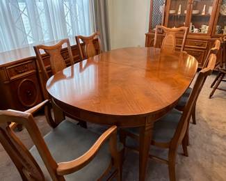 Vintage solid cherry expandable dining table with lovely patterned top veneer. As shown it is 62” x 42”, and comes with three 12” extensions (for a full 98” table), 6 chairs  and a custom table pad.