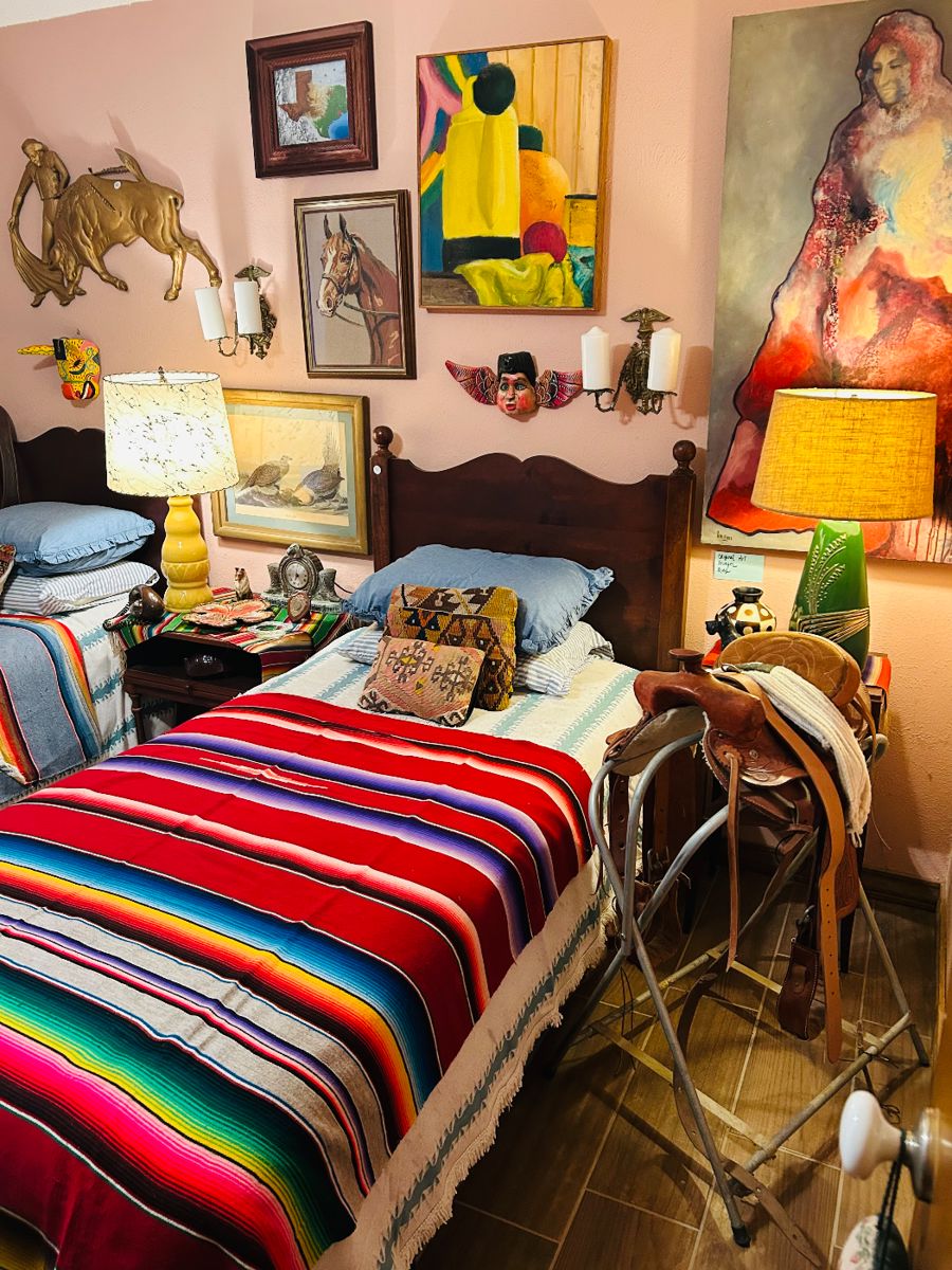 Western room designed by Ralph Lauren himself and the lovely Laura Kuykendall. Western saddle, original artwork, Mid Century Modern Lamps and decor.  