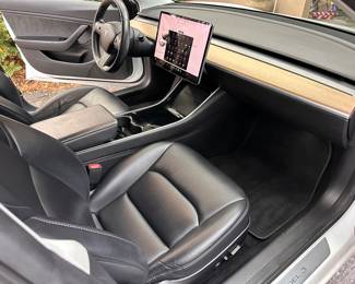 The LCD Screen is the primary control center, displaying vital driving information like speed, battery life, navigation, climate control, media, and various vehicle settings. 