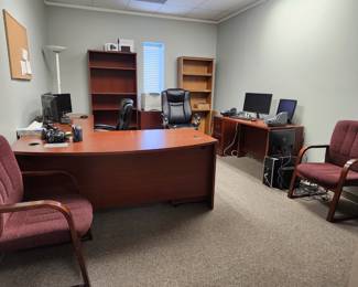 Chairs, bookcases, desks, monitors, lamp, corkboard