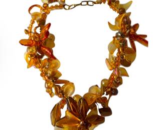 Large statement plastic floral necklace.  We have found only one like it, listed on eBay, and suggesting it might be Haskell or Rousellet, but we have been unable to verify the maker.  The eBay listing is just under $3000.