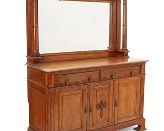 1491
Early 20th century
An English oak mirrored sideboard
The mirror centering opposed turned columns with Ionic capitals surmounted by an architectural cornice, mounted to a lower console with two drawers above three hinged cabinet doors, the right revealing a small metal cubby, the center featuring a later mounted zoomorphic mask, 2 pieces
Overall: 77.25" H x 60.5" W x 24" D; Mirror console: 42.25" H x 63" W x 11.5" D; Lower console: 38" H
Estimate: $600 - $800