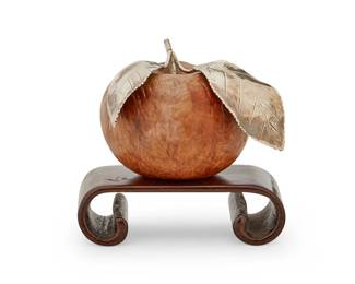 1331
20th century
A German silver and carved wood apple
Marked for 835 silver purity and with maker's mark: LF; further marked illegibly
The carved burlwood apple with mounted silver leaves, set on a carved wood base with scrolled legs
Apple overall: 2.25" H x 3.25" W x 2.875" D; Stand: 1" H x 3.5" W x 1.75" D
Estimate: $200 - $300